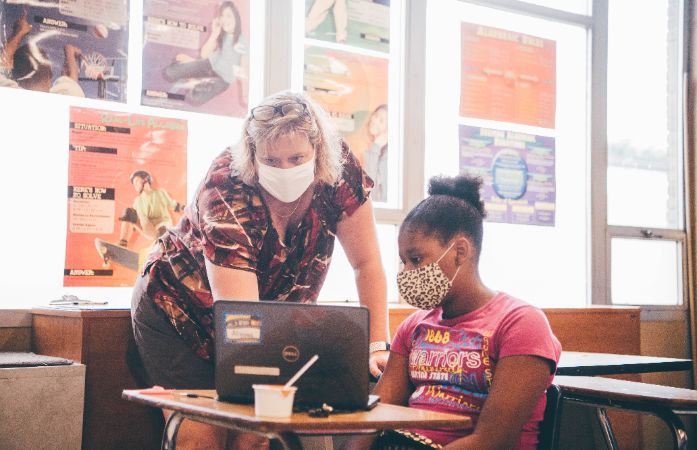 teacher helping student